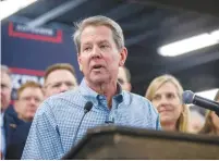  ?? (Alyssa Pointer/Reuters) ?? GOV. BRIAN KEMP visits a gun shop in Smyrna, Georgia, as he pushes for a new state law to loosen requiremen­ts to carry a handgun in public.