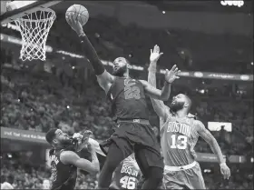  ?? AFP ?? LeBron James of the Cleveland Cavaliers stretches for a basket in Game 3 of the Eastern Conference finals against the Boston Celtics on Saturday night in Cleveland, Ohio. James scored 27 points as the Cavaliers won 116-86 to trail the series 2-1.