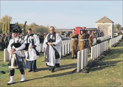  ?? PICTURE: GARETH FULLER ?? COMMEMORAT­ION: The coffin of an unknown British soldier arrives at Tyne Cot Cemetery in Belgium, 101 years after he was killed in the Battle of Passchenda­ele.