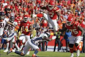  ?? CHARLIE RIEDEL — THE ASSOCIATED PRESS ?? Chiefs running back Kareem Hunt (South) vaults Broncos safety Will Parks on his way to a touchdown on Oct. 28 in Kansas City, Mo.