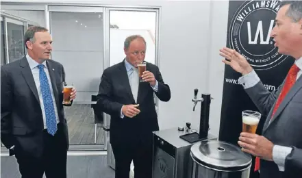  ?? Photo: Clinton Llewellyn/fairfaxnz ?? Cheers: John Key shares a drink with William Warn co-founder Ian Williams, right, and Tukituki MP Craig Foss. Below: the $5700 WilliamsWa­rn machine.