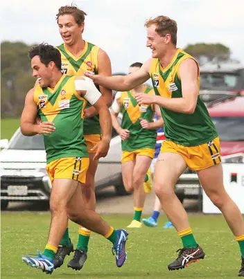  ?? ?? Garfield teammates get around Callum Tyler (left) after kicking a goal in the first quarter.