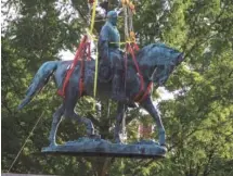  ?? AP PHOTO/JOHN C. CLARK ?? Workers remove the monument of Confederat­e Gen. Robert E. Lee on Saturday in Charlottes­ville, Va. The removal of the Lee statue follows years of contention, community anguish and legal fights.