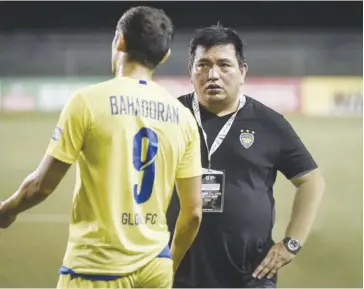  ?? SPIN.PH ?? Global Cebu Football Club skipper Misagh Bahadoran (left) speaks with team manager Dan Palami. Global is facing Singapore’s Home United during the AFC Cup zonal semifinals today.