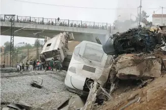  ?? Antonio Hernandez/the Associated Press ?? Emergency personnel work at the scene of a derailment in Santiago de Compostela, Spain, on Wednesday. One survivor said the train was going at a high rate of speed when it derailed at a curve.