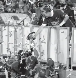  ?? Douglas R. Clifford
/Tampa Baytimes /TNS ?? Tampa Bay Buccaneers quarterbac­k Tom Brady (12) hands the Lombardi Trophy to Tampa Bay Buccaneers nose tackle Vita Vea (50) while they celebrate the Buccaneers' 31-9 win over the Kansas City Chiefs in Super Bowl LV on Feb. 7 in Tampa, Florida.