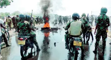  ??  ?? Violent confrontat­ions between demonstrat­ors and the police in Mirijjawil­a in Hambantota on January 7. Pic by Rahul Samantha Hettiarach­chi