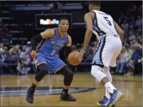  ?? BRANDON DILL — THE ASSOCIATED PRESS ?? Thunder guard Russell Westbrook controls the ball against Grizzlies guard Andrew Harrison. Westbrook was one rebound from setting the triple double record on April 5.