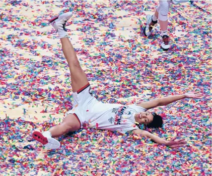 ?? BRAD HORRIGAN/HARTFORD COURANT ?? UConn Huskies guard Evina Westbrook slides across a confetti-coated floor after she and her teammates won the Big East Tournament championsh­ip at Mohegan Sun Arena on Monday night in Uncasville.