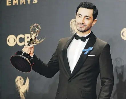  ?? Allen J. Schaben Los Angeles Times ?? RIZ AHMED shows off his statuette for “The Night Of.” He is the first Muslim, and the first Asian, to win a lead acting Emmy.