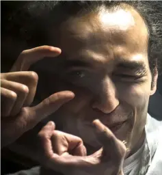  ??  ?? File photo shows Mahmoud Abdel Shakour, known as Shawkan, gesturing from inside a soundproof glass dock, during his trial in Cairo. — AFP photo