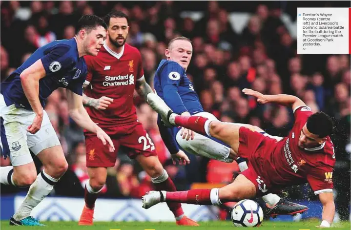  ?? AP ?? Everton’s Wayne Rooney (centre left) and Liverpool’s Dominic Solanke battle for the ball during the Premier League match at Goodison Park yesterday.