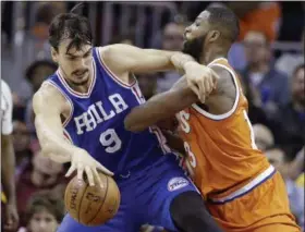  ?? TONY DEJAK — THE ASSOCIATED PRESS ?? Philadelph­ia’s Dario Saric, left, tries to get past the Cavaliers’ Tristan Thompson in the first half of a March 31 game at Quicken Loans Arena.