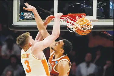  ?? Associated Press ?? Slammed: Tennessee guard Dalton Knecht (3) dunks the ball against Texas forward Dylan Disu (1) during the second half of a second-round college basketball game in the NCAA Tournament Saturday in Charlotte, N.C.