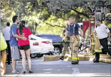  ?? PHOTOS BY LAURA SKELDING / AMERICAN-STATESMAN ?? Three Austin firefighte­rs suffered second-degree burns and some 20 to 30 residents were displaced in a three-alarm condominiu­m complex fire in Northwest Austin on Sunday morning. Nima Aghili and Nora Roostaie (left) live in the complex and had to...