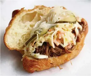  ??  ?? The newly-launched (and very delicious) Brimmie Sammich is made up of pulled lamb, coleslaw, pickled cucumber and onion in a soft croissant.