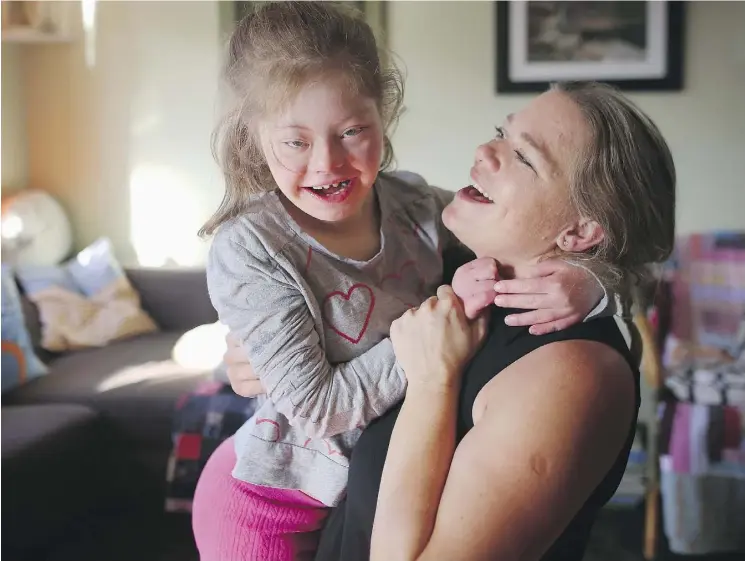  ?? LEAH HENNEL ?? Calgary Herald photojourn­alist Christina Ryan dances with daughter Emily Pitchers,16, who has numerous medical conditions including Down Syndrome.