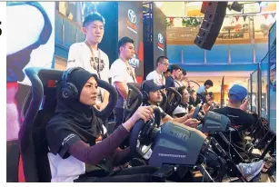  ??  ?? Toyota Gazoo Racing local celebritie­s trying their hand at the simulated race of the Toyota Velocity eSports champhions­hip.