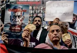  ?? MOHAMED EL RAAI/ASSOCIATED PRESS ?? Egyptian activists held bread as they participat­ed in a proPalesti­nian protest in Cairo on April 3.