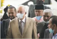  ?? Associated Press ?? Former Malaysian Prime Minister Najib Razak (left) arrives at the courthouse in Kuala Lumpur.