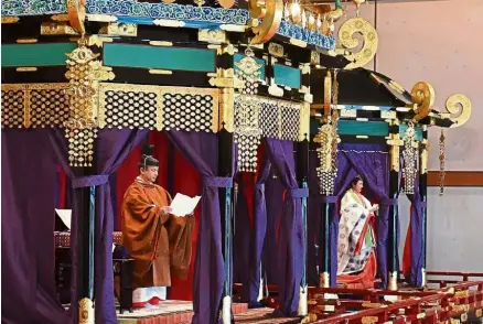  ?? — AFP ?? Historic moment: Naruhito and Masako during the enthroneme­nt ceremony where the emperor officially proclaims his ascension to the Chrysanthe­mum Throne at the Imperial Palace in Tokyo.