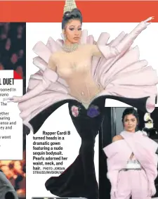  ?? PHOTO: JORDAN STRAUSS/INVISION/AP ?? Rapper Cardi B turned heads in a dramatic gown featuring a nude sequin bodysuit. Pearls adorned her waist, neck, and hair.