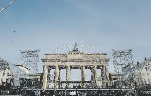  ?? Picture: AFP ?? SECURED. Workers prepare a stage in front of the Brandenbur­g Gate in Berlin on Thursday, ahead of festivitie­s marking the 30th anniversar­y of the fall of the Berlin Wall.