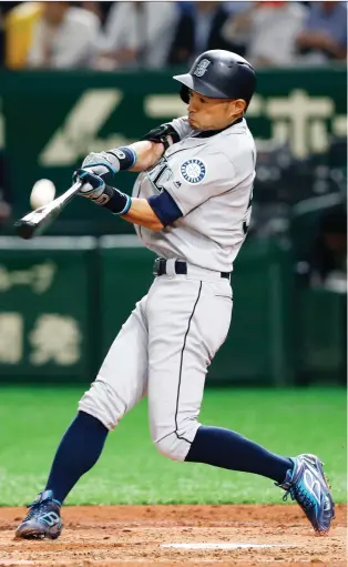  ?? TORU TAKaHASHI/THE ASSOCIATED PRESS ?? The Mariners’ Ichiro Suzuki fouls off a ball against the Oakland A’s on Wednesday during the MLB season-opener in Tokyo. The outfielder popped up and walked in the 9-7 Seattle win.