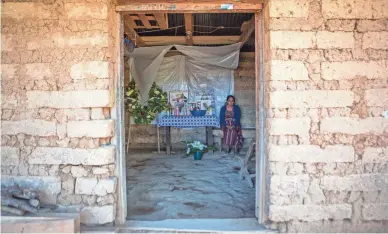  ?? OLIVER DE ROS/AP ?? Natalia Tomas keeps vigil next to an altar adorned with photos of her son Ivan Gudiel in her home in Comitancil­lo, Guatemala. She believes that her son is one of the charred corpses found in northern Mexico.