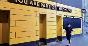  ?? PHOTO: REUTERS ?? No show . . . A man walks past a show venue of standup comedy company Xiaoguo Culture Media Co, which has been barred from operating its business in Beijing.