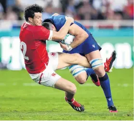  ?? PHOTO: GETTY IMAGES ?? Crunch . . . Sebastian Negri, of Italy, is tackled by Canada’s Ciaran Hearn during their group B game at Fukuoka Hakatanomo­ri Stadium last night.