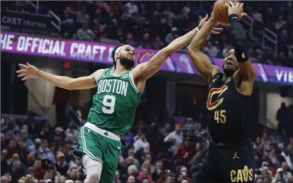  ?? RON SCHWANE — THE ASSOCIATED PRESS ?? Cleveland Cavaliers guard Donovan Mitchell (45) shoots against Boston Celtics guard Derrick White (9) during the first half of an NBA basketball game, Monday, March 6, 2023, in Cleveland.