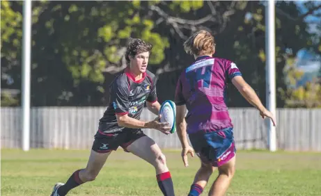  ??  ?? EYES UP: Angus Brennand tries to scheme a passage past the Toowoomba Bears’ defence. Gatton prevailed in the round one Risdon Cup clash at Heritage Oval. Pictures: Nev Madsen