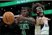  ?? STUART CAHILL — BOSTON HERALD ?? Boston Celtics guard Jrue Holiday (4) and Dallas Mavericks center Dereck Lively II battle for the ball as the Celtics take on the Mavericks at the TD Garden on March 1.