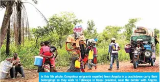  ??  ?? In this file photo, Congolese migrants expelled from Angola in a crackdown carry their belongings as they walk to Tshikapa in Kasai province, near the border with Angola. The coronaviru­s has brought oil drilling to a halt in Angola, Africa’s second-largest oil producer. — Reuters