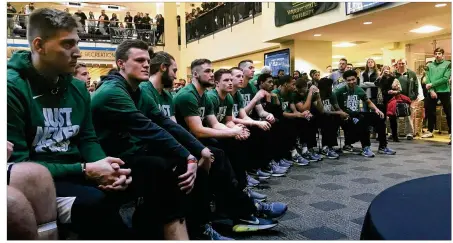  ?? JAY MORRISON / STAFF ?? Members of the Wright State basketball team await the announceme­nt of who, where and when they will play during a selection show watch party at the WSU Student Union on Sunday.