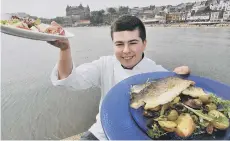  ??  ?? Student Kieran Newton with some prepared food on the pier 181970w