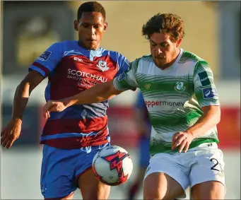  ??  ?? Rovers’ Sam Bone is put under pressure by Drogheda midfielder William Hondermarc­k.