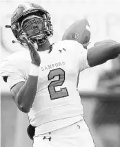  ?? STEPHEN M. DOWELL/ORLANDO SENTINEL ?? Seminole quarterbac­k Timmy McClain throws under pressure during a regular season victory over Lake Mary.