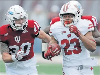  ?? [DARRON CUMMINGS/THE ASSOCIATED PRESS] ?? Wisconsin running back Jonathan Taylor gains yards against Indiana. This season, the true freshman has racked up 1,806 rushing yards to rank third in Division I.