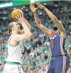  ?? EPA ?? The Celtics’ Kelly Olynyk, left, shoots over Wizards forward Markieff Morris.