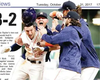  ??  ?? The Houston Astros celebrate after Alex Bregman, left, hit the gamewinnin­g single in the 10th inning during Game 5 of the World Series against the Los Angeles Dodgers Monday in Houston. Astros won 13-12 to take a 3-2 lead. (AP)
