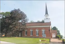  ?? STAFF PHOTOS BY JAMIE ANFENSON-COMEAU ?? Above, St. Ignatius Catholic Church, built in 1798, sits on a site first claimed by the Catholic Society of Jesus in 1641 as part of their mission work with local American Indian tribes. Below, the cemetery behind St. Ignatius Church looks out over the...