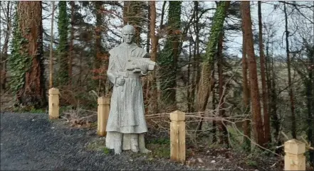  ??  ?? A stone monk greets walkers at the entrance to the looped forest walkway along the river Barrow.