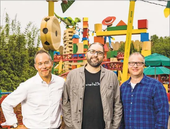  ?? Matt Stroshane Disney ?? “TOY STORY 4” director Josh Cooley is flanked by the animated film’s producers Jonas Rivera, left, and Mark Nielsen at Disney’s Hollywood Studios in Orlando, Fla.