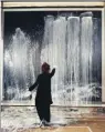  ??  ?? This page: Pat Steir at work in her studio
in 1990