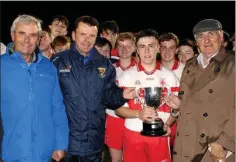  ??  ?? Ballinastr­agh Gaels accepting the cup from Bobby Goff (Coiste na nOg), Dermot Howlin (representi­ng the Ferguson family, who donated the Seán Ferguson Memorial Cup), and Brendan Furlong of People Newspapers.