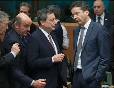  ?? (Yves Herman/Reuters) ?? EUROPEAN CENTRAL BANK President Mario Draghi is flanked by Spanish Economy Minister Luis de Guindos (second from left) and Eurogroup chairman Jeroen Dijsselblo­em at a meeting of euro-zone finance ministers yesterday in Brussels.