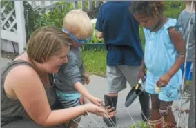  ?? JOSEPH PHELAN -- JPHELAN@DIGITALFIR­STMEDIA.COM ?? Pre-K in the Park students plant flowers Friday at Shelters of Saratoga.