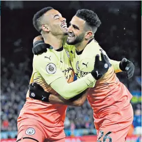  ??  ?? That winning feeling: Manchester City striker Gabriel Jesus (left) gets a hug from team-mate Riyad Mahrez after scoring the only goal of the game at Leicester